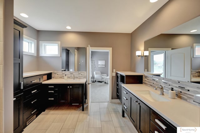 bathroom with vanity and tasteful backsplash