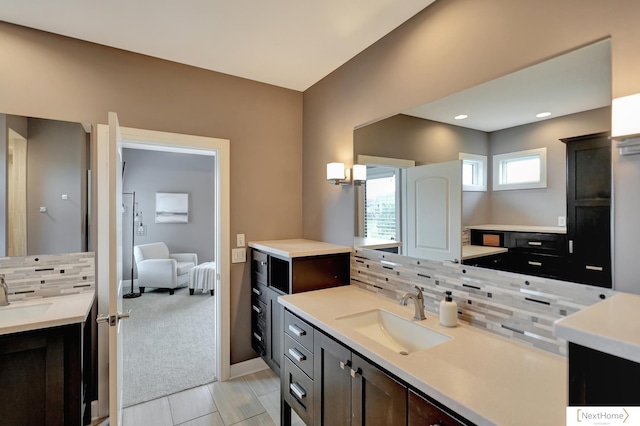 bathroom with decorative backsplash and vanity