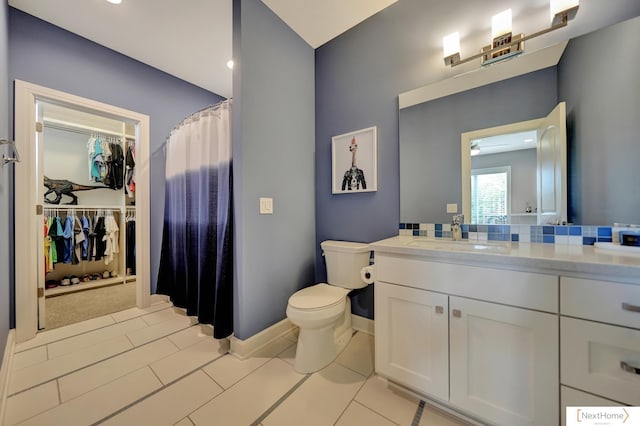 bathroom featuring tile patterned flooring, vanity, and toilet