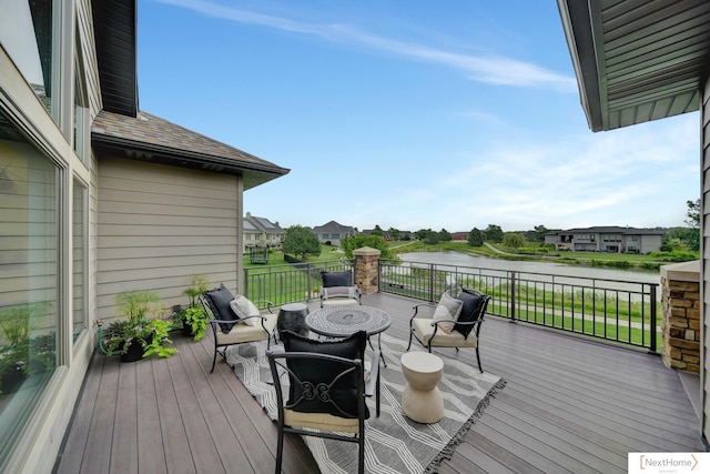 wooden terrace featuring a water view