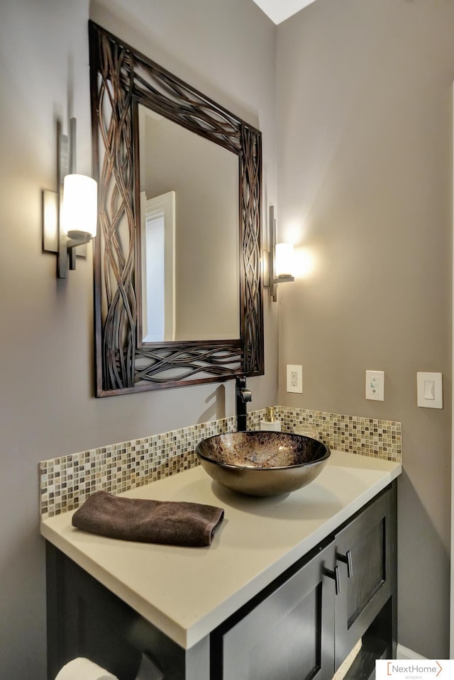 bathroom with tasteful backsplash and vanity