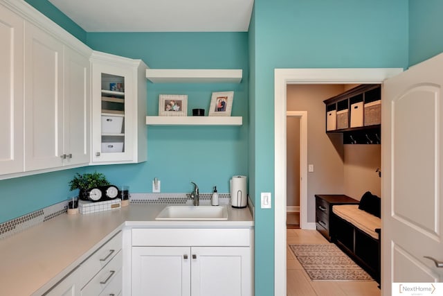 kitchen featuring white cabinets and sink