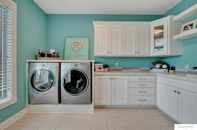 laundry room with cabinets, washing machine and dryer, and sink