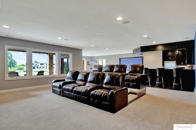 home theater room featuring carpet flooring and a wealth of natural light