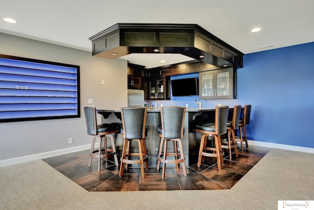 bar featuring stainless steel fridge