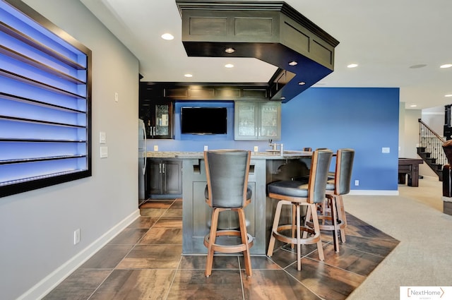 bar featuring light stone countertops