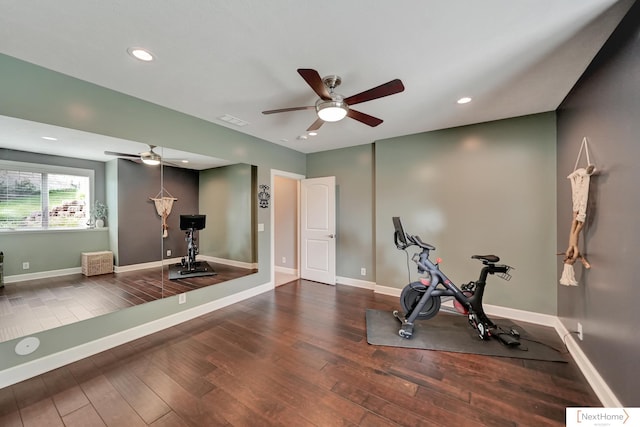 exercise room with ceiling fan and dark hardwood / wood-style flooring