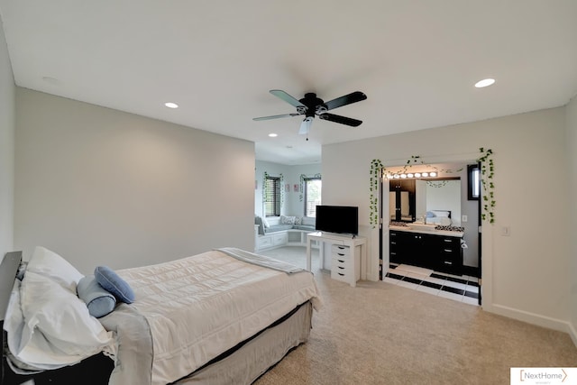 carpeted bedroom with ceiling fan and connected bathroom