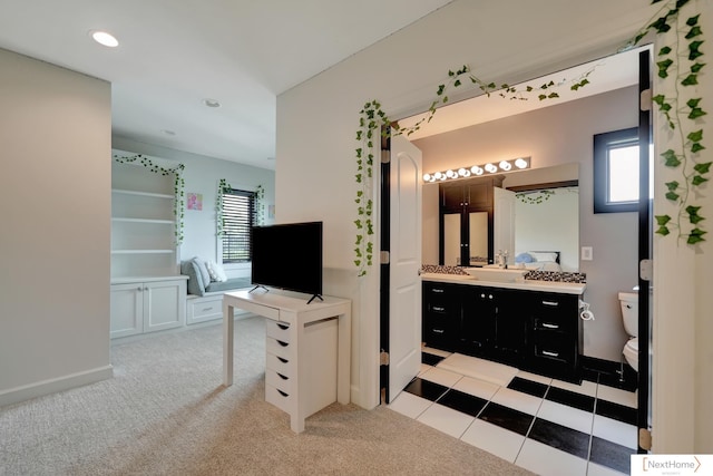 bathroom with vanity, a healthy amount of sunlight, and toilet