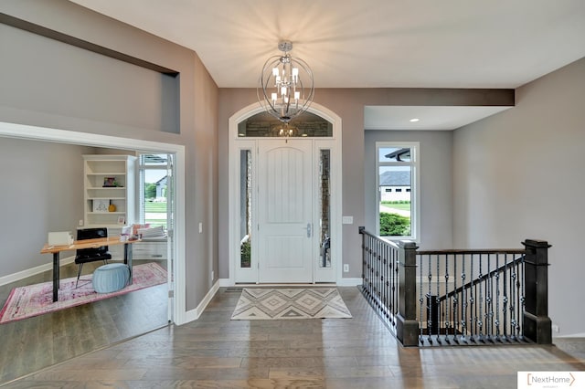 entryway featuring dark hardwood / wood-style flooring and an inviting chandelier