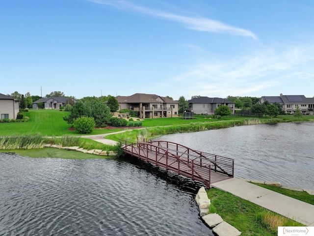 view of dock featuring a water view and a lawn