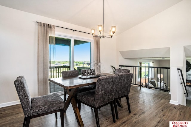 dining room with a wealth of natural light, dark hardwood / wood-style flooring, lofted ceiling, and a notable chandelier