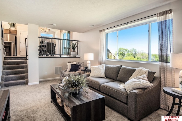 living room featuring carpet floors and a textured ceiling