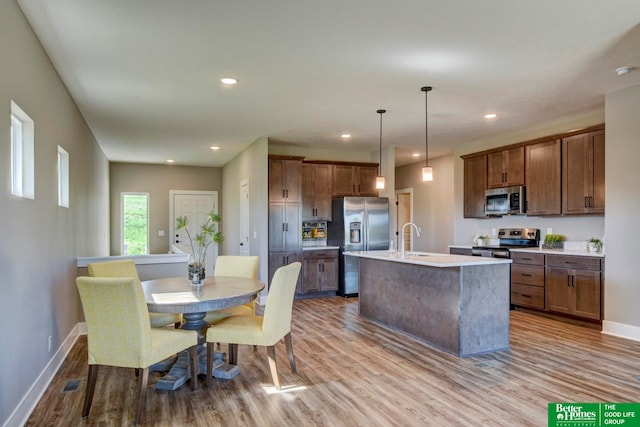 kitchen featuring appliances with stainless steel finishes, sink, and hardwood / wood-style flooring