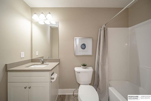 full bathroom with vanity, toilet, wood-type flooring, and shower / bath combo