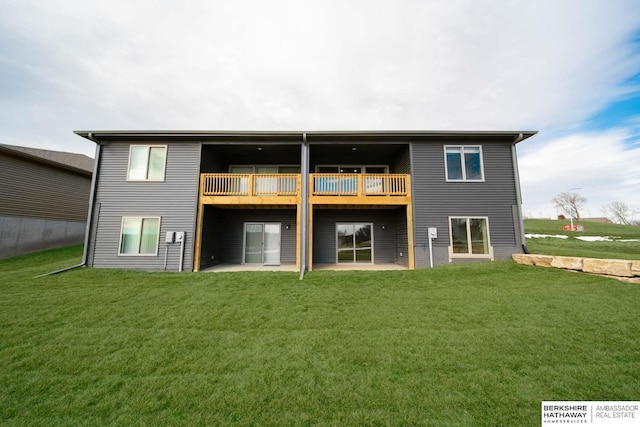 rear view of property with a yard and a patio