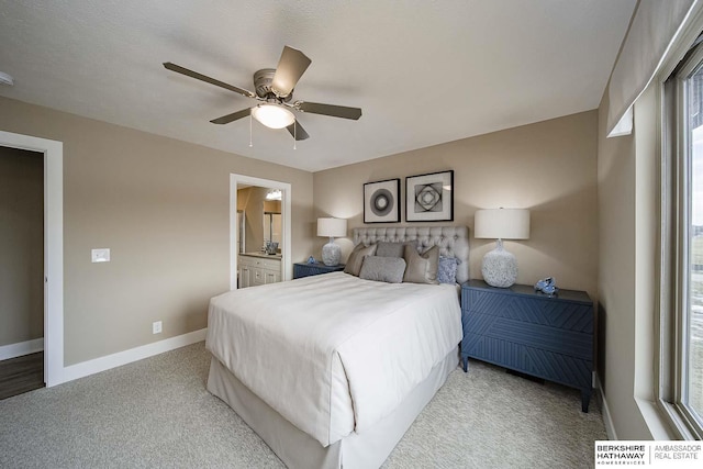 carpeted bedroom featuring ensuite bath and ceiling fan