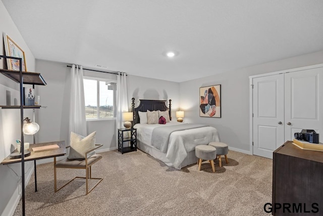 bedroom featuring light carpet and a closet