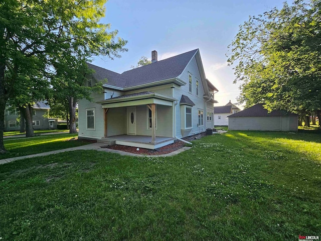 property exterior at dusk with a patio and a yard