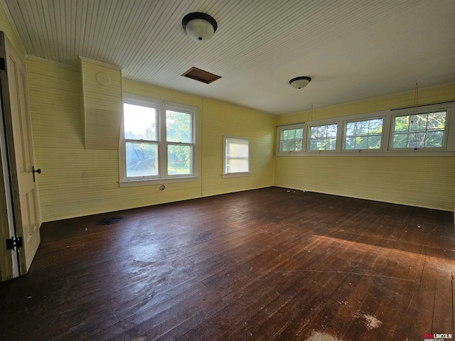 spare room featuring dark hardwood / wood-style flooring