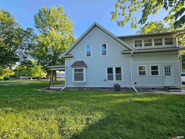 back of property featuring a lawn