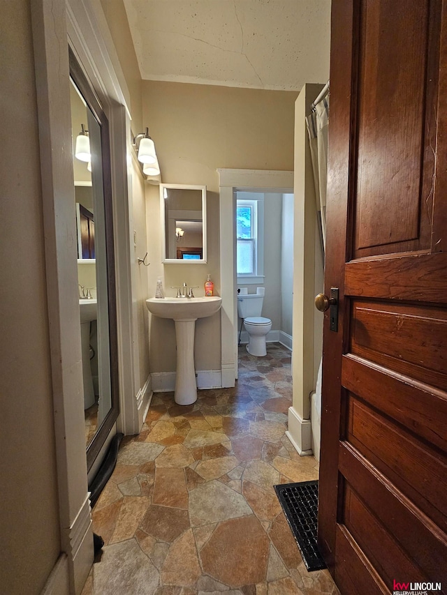 bathroom with tile floors, walk in shower, and toilet