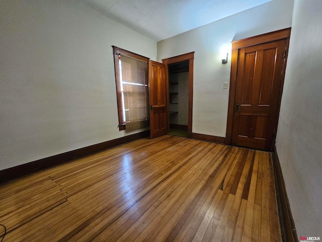 unfurnished bedroom with dark wood-type flooring