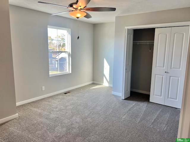 unfurnished bedroom with ceiling fan, a closet, and carpet