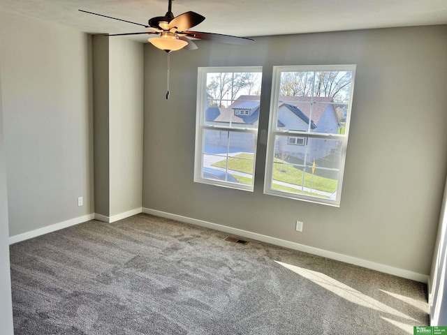 unfurnished room with carpet, healthy amount of natural light, and a ceiling fan