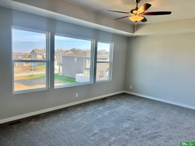 carpeted empty room featuring ceiling fan