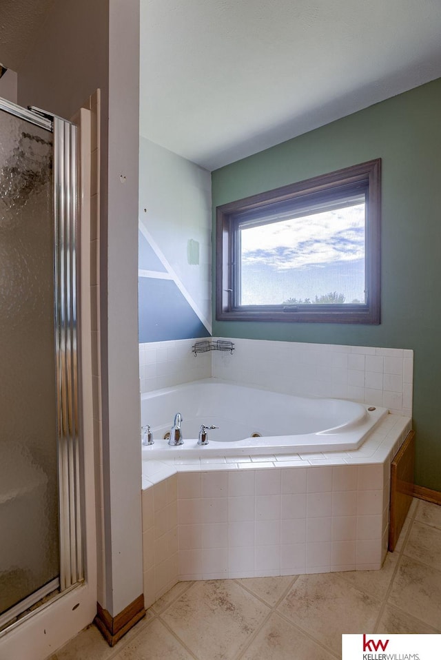 bathroom with shower with separate bathtub and tile patterned floors