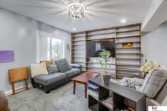 carpeted living room featuring a textured ceiling