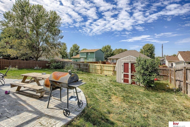 view of yard featuring a shed and a patio area