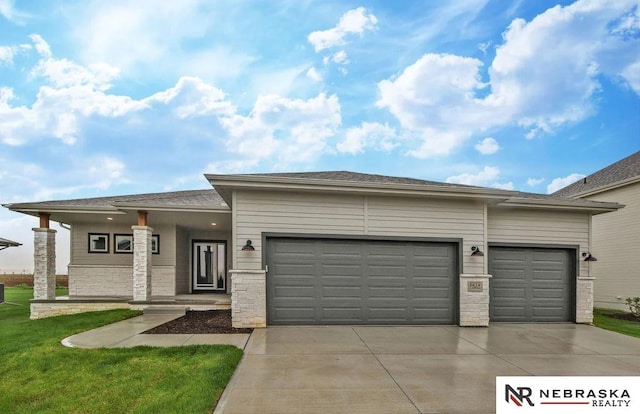 view of front of property with a garage and a front lawn