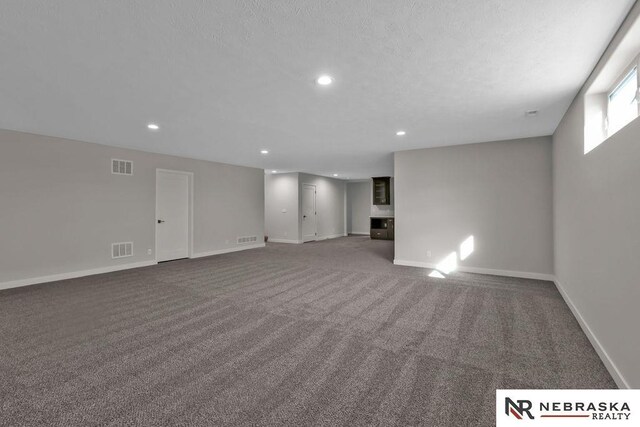 carpeted bedroom featuring ensuite bath, ceiling fan, and a raised ceiling