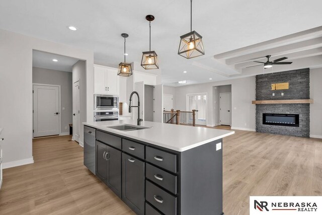 kitchen featuring light carpet, sink, and white cabinets