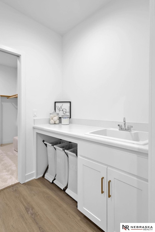 interior space with sink and hardwood / wood-style flooring