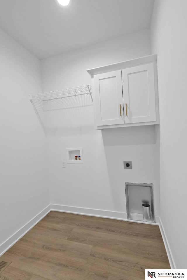 laundry area featuring hardwood / wood-style floors, washer hookup, cabinets, and hookup for an electric dryer