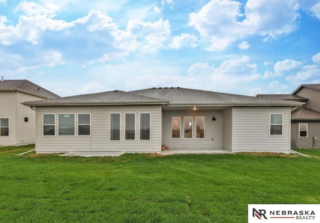 rear view of house with a patio area and a lawn