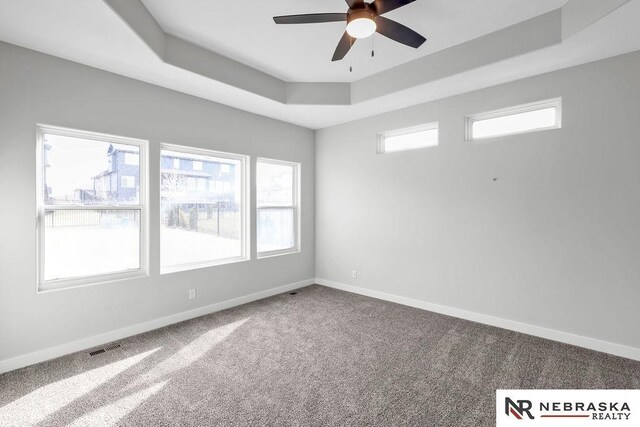 living room featuring a large fireplace, ceiling fan, a water view, and light hardwood / wood-style flooring