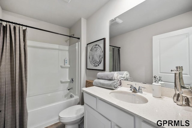 full bathroom featuring toilet, shower / bath combination with curtain, and vanity