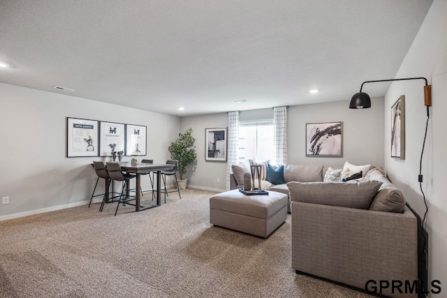 carpeted living area with recessed lighting, visible vents, a textured ceiling, and baseboards