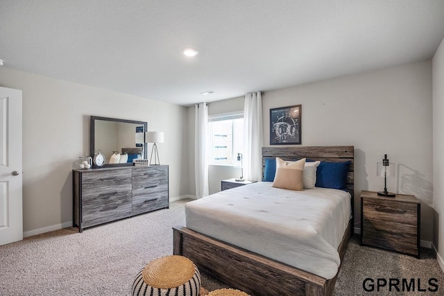 bedroom featuring carpet and baseboards