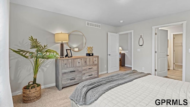 bedroom featuring light carpet