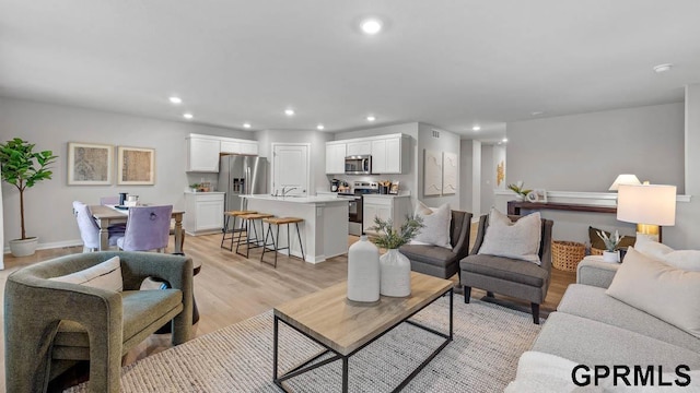 living room with light hardwood / wood-style flooring