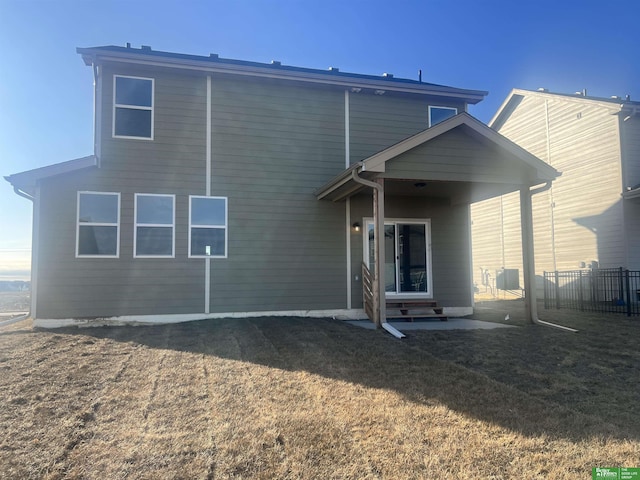 rear view of property featuring a yard