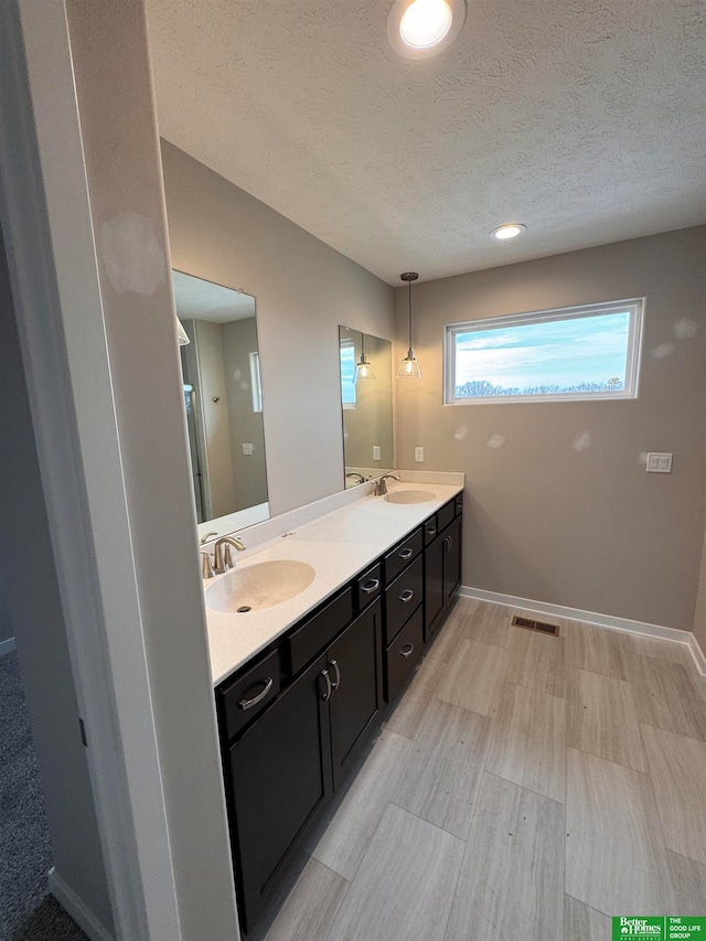 bathroom with vanity and a textured ceiling