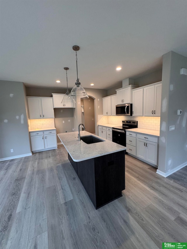 kitchen featuring white cabinets, sink, and appliances with stainless steel finishes