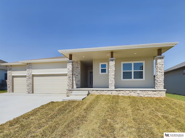 prairie-style house with a front yard, a garage, and covered porch