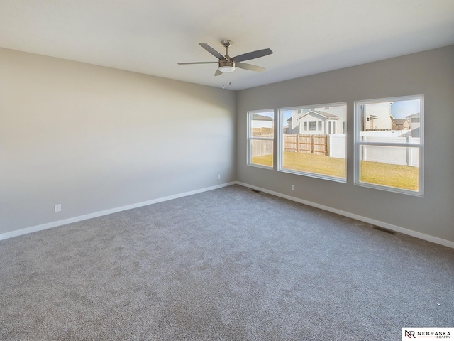 unfurnished room with ceiling fan and carpet floors